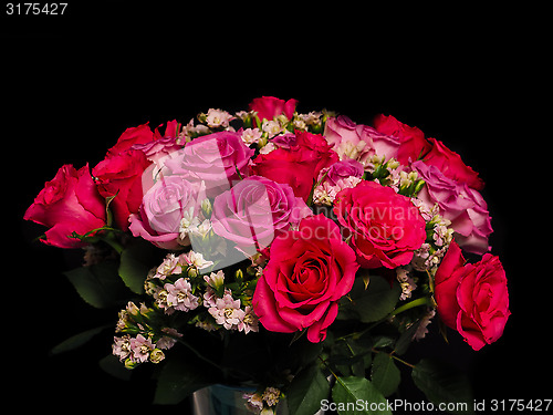 Image of Bouquet of pink roses at closeup towards black background