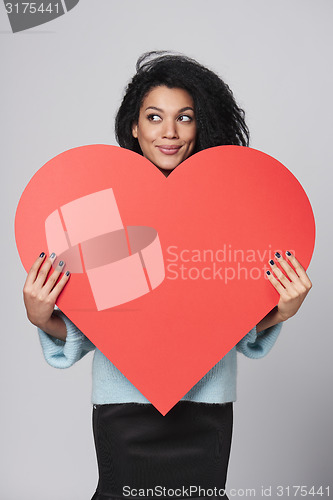 Image of Girl holding big red heart shape