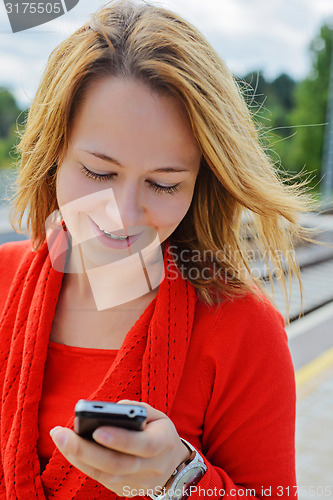 Image of Young beautiful girl using mobile phone