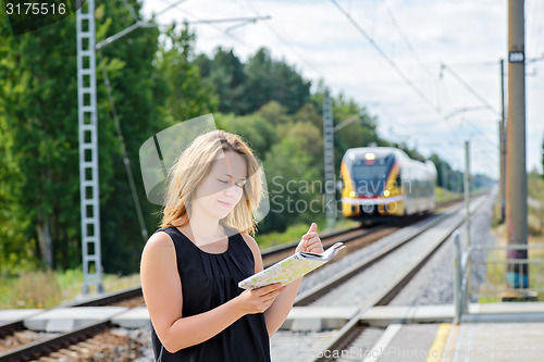 Image of Female waiting train on the platform 