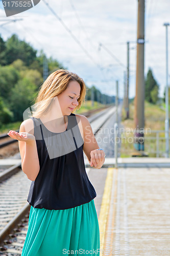 Image of Female waiting train on the platform 