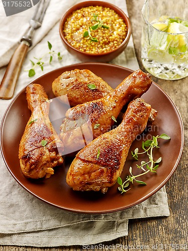 Image of chicken legs on brown plate