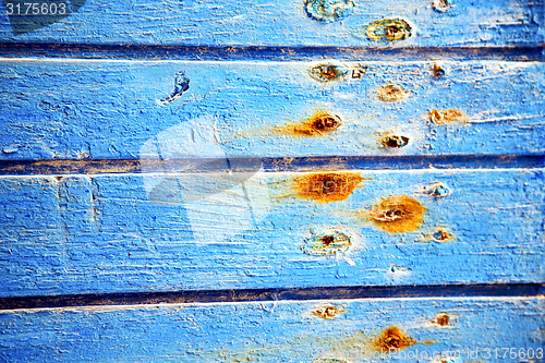 Image of dirty stripped   in the blue  door and rusty  