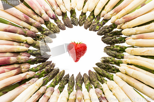 Image of White And Green Asparagus Tips Point At Strawberry