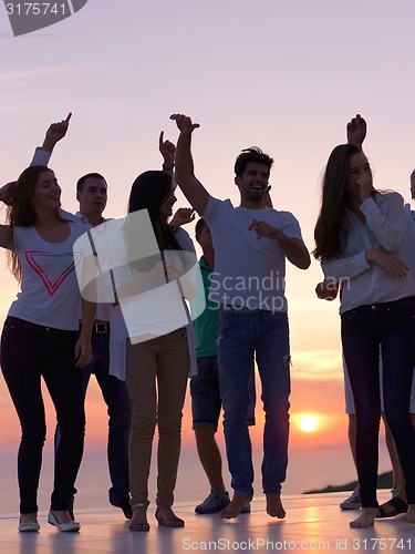 Image of party people  on sunset