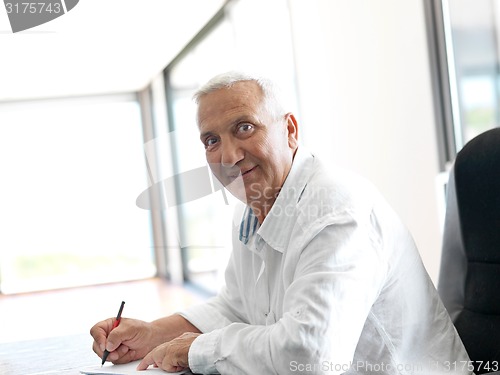 Image of Portrait of senior man relaxing in sofa