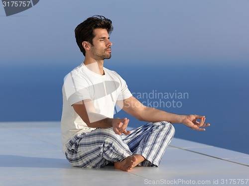 Image of young man practicing yoga