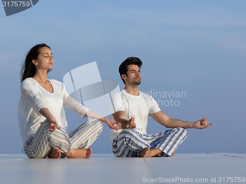 Image of young couple practicing yoga