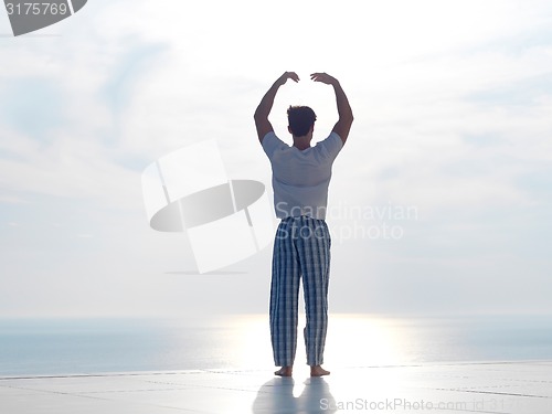 Image of young man practicing yoga