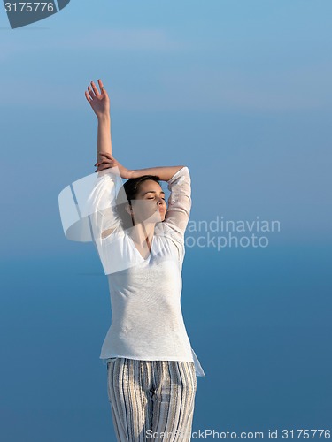 Image of young woman enjoy sunset