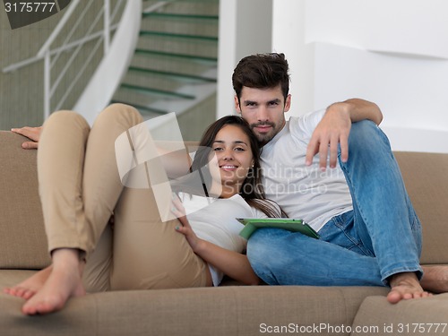 Image of young couple making selfie together at home