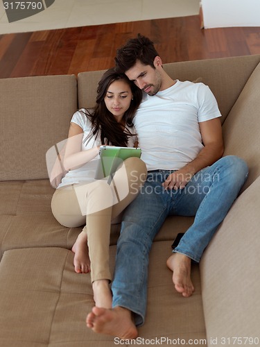 Image of young couple making selfie together at home