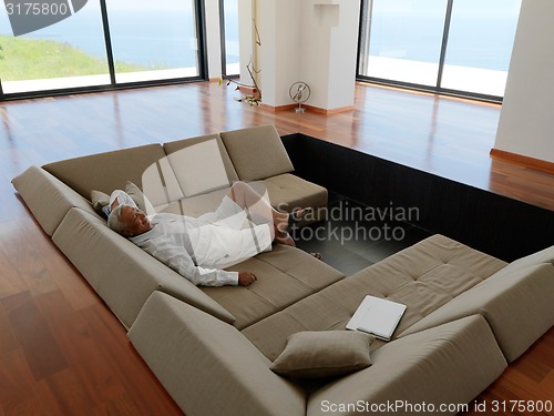 Image of Portrait of senior man relaxing in sofa