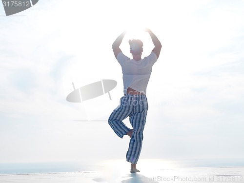 Image of young man practicing yoga