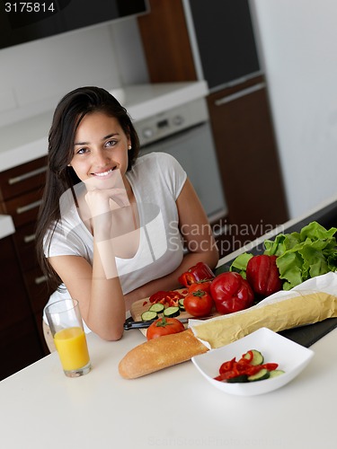 Image of Young Woman Cooking in the kitchen