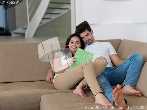 Image of young couple making selfie together at home