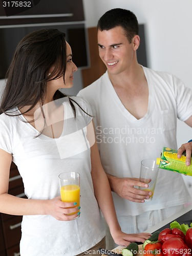 Image of happy young couple in kicthen