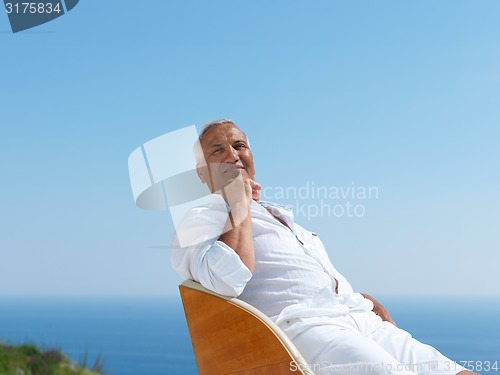 Image of senior man sitting outside