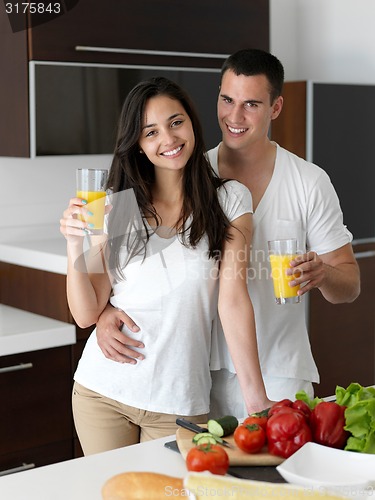 Image of happy young couple in kicthen