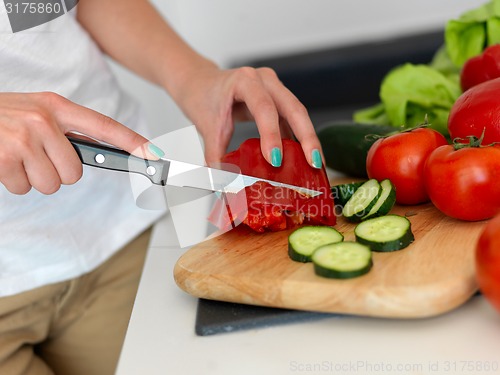 Image of Young Woman Cooking in the kitchen