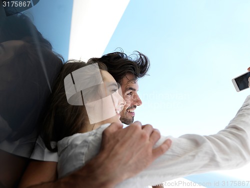 Image of young couple making selfie together at home