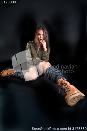 Image of Portrait of young pretty woman in boots