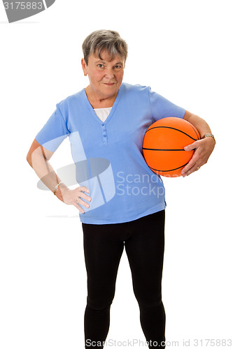 Image of Senior woman carrying a basketball