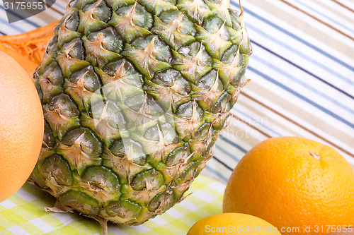 Image of fresh pineapple with corn and orange