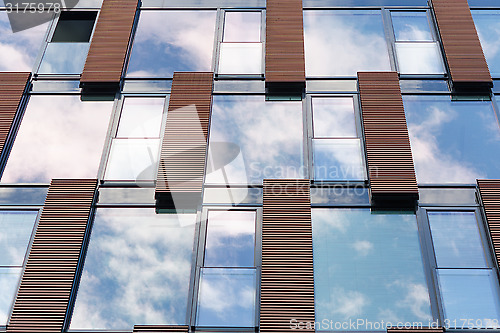 Image of Blue sky reflected in mirror windows of modern office building