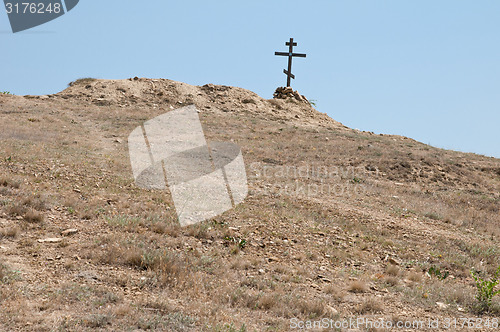 Image of wooden cross on the hill