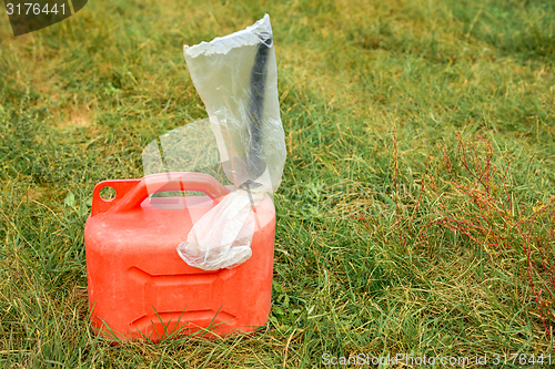 Image of Red jerrycan on green grass
