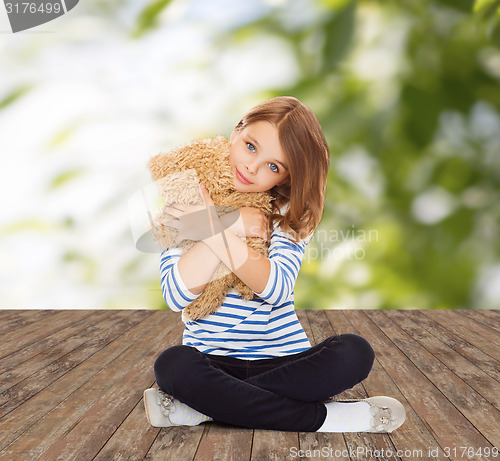 Image of cute little girl hugging teddy bear