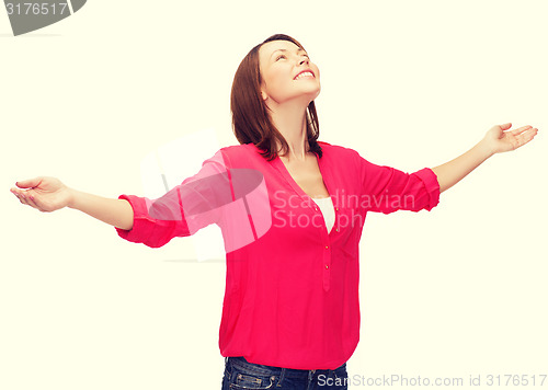 Image of smiling woman waving hands with closed eyes