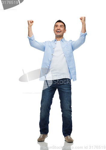 Image of happy laughing man with raised hands