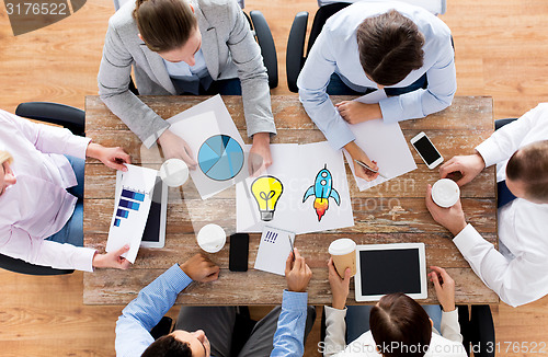 Image of close up of business team with coffee and papers