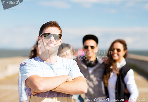 Image of teenager in shades outside with friends