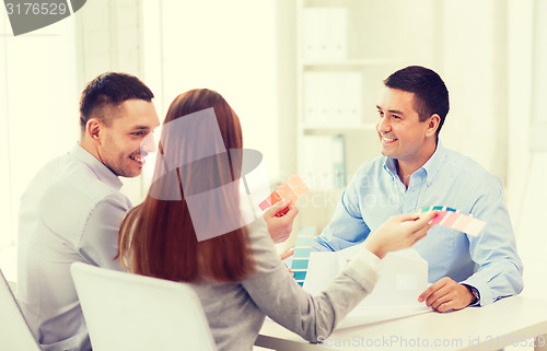 Image of couple looking at model of their house at office