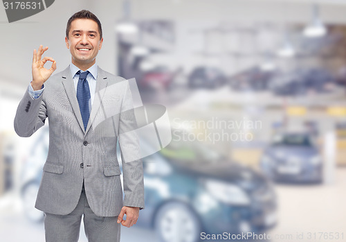 Image of happy man at auto show or car salon