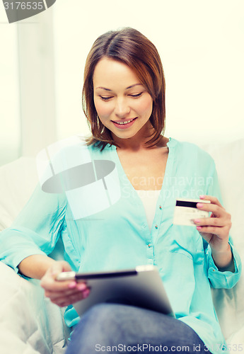 Image of smiling woman with tablet pc computer at home