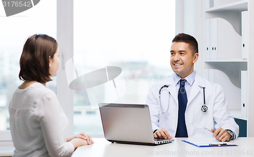 Image of smiling doctor and young woman meeting at hospital
