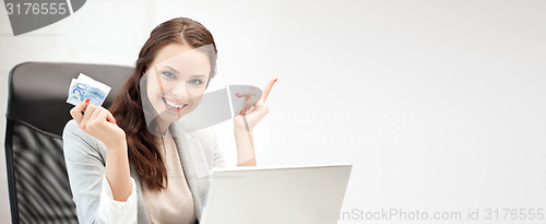 Image of happy woman with computer and euro cash money