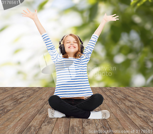 Image of happy girl with headphones listening to music