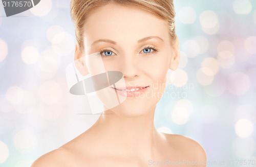 Image of beautiful young woman face over blue background