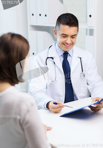 Image of smiling doctor and young woman meeting at hospital