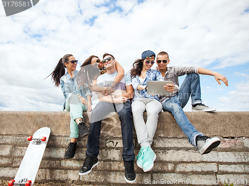 Image of group of teenagers looking at tablet pc