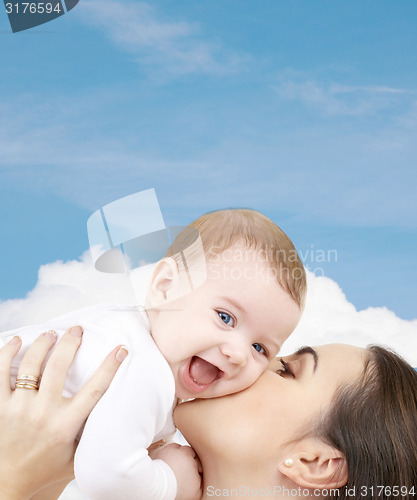 Image of laughing baby playing with mother