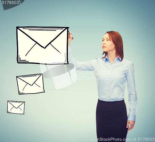 Image of businesswoman drawing envelope on virtual screen