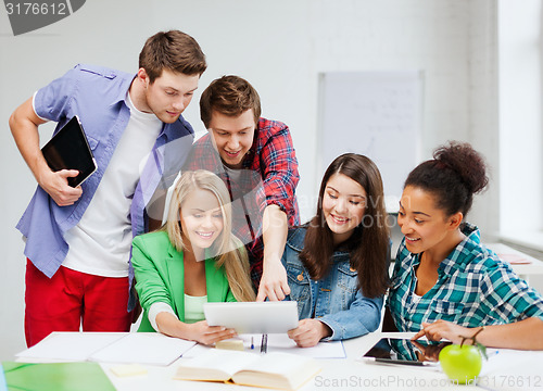 Image of students looking at tablet pc at school