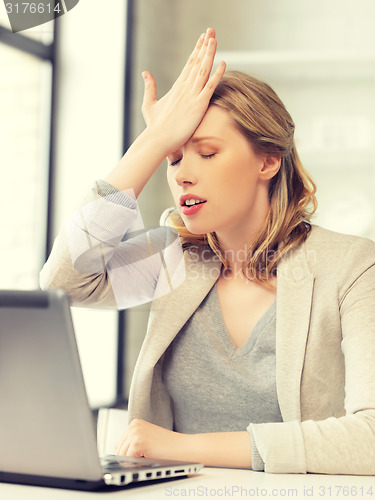 Image of stressed woman with laptop computer