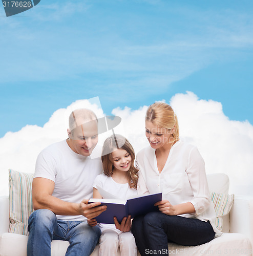 Image of happy family with book at home